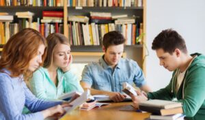 Group of young students studying in library