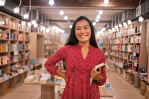 Portrait of female librarian/bookseller during her workday in the library