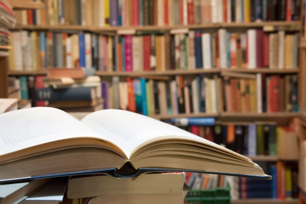 Open book in front of library shelf