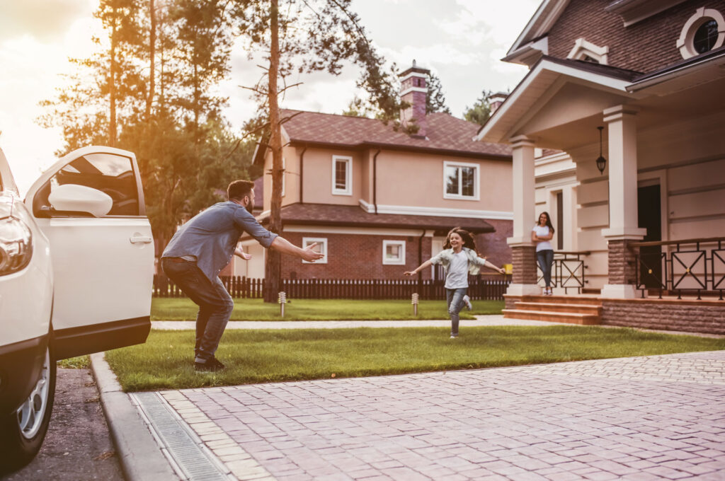 Family in front yard covered by personal insurance